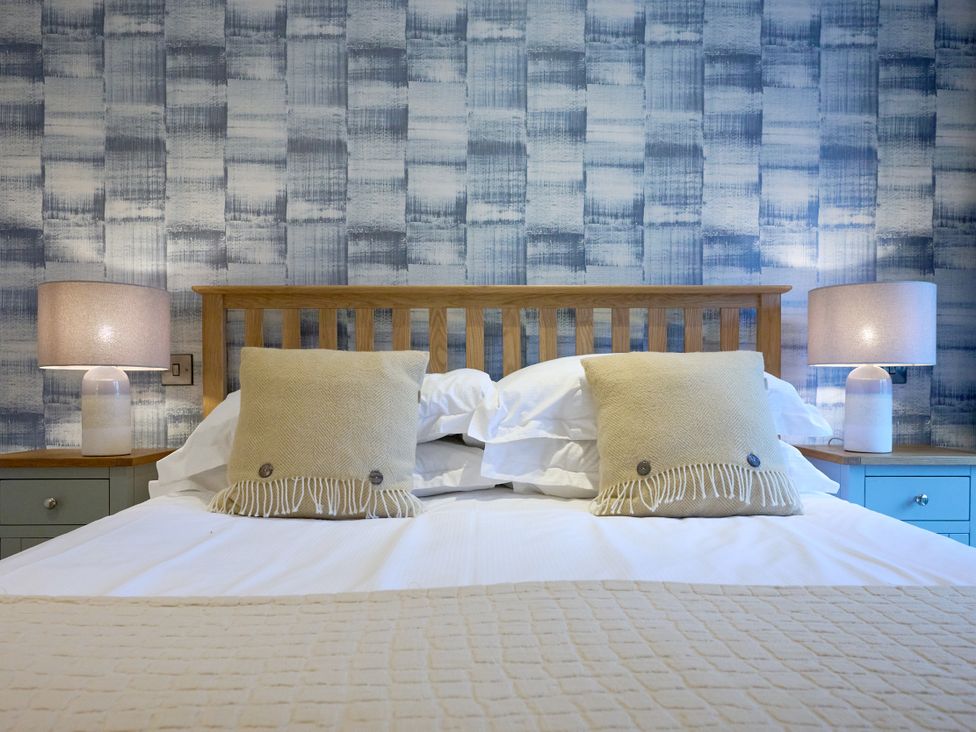 A bedroom with a bed and pillows at Riverside Park 1 in Keswick