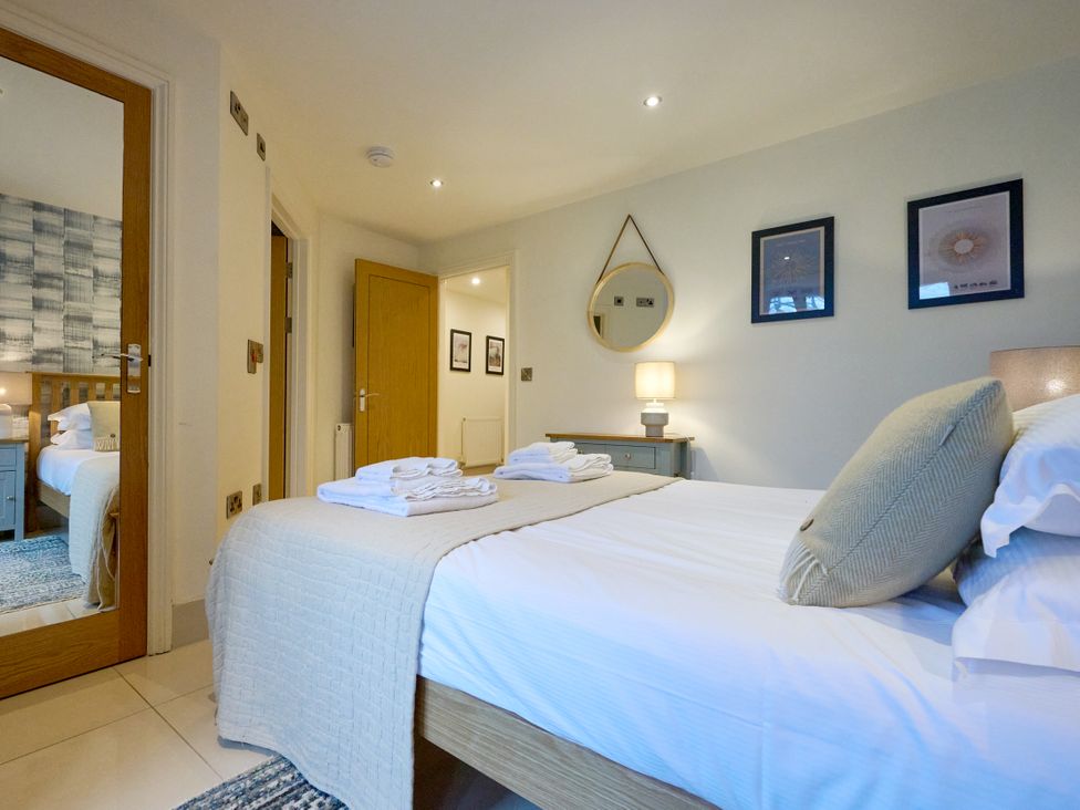 A bedroom with a bed and lamp at Riverside Park 1 in Keswick