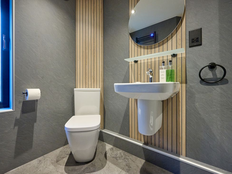 A bathroom with a toilet and wash basin at Riverside Park 1 in Keswick