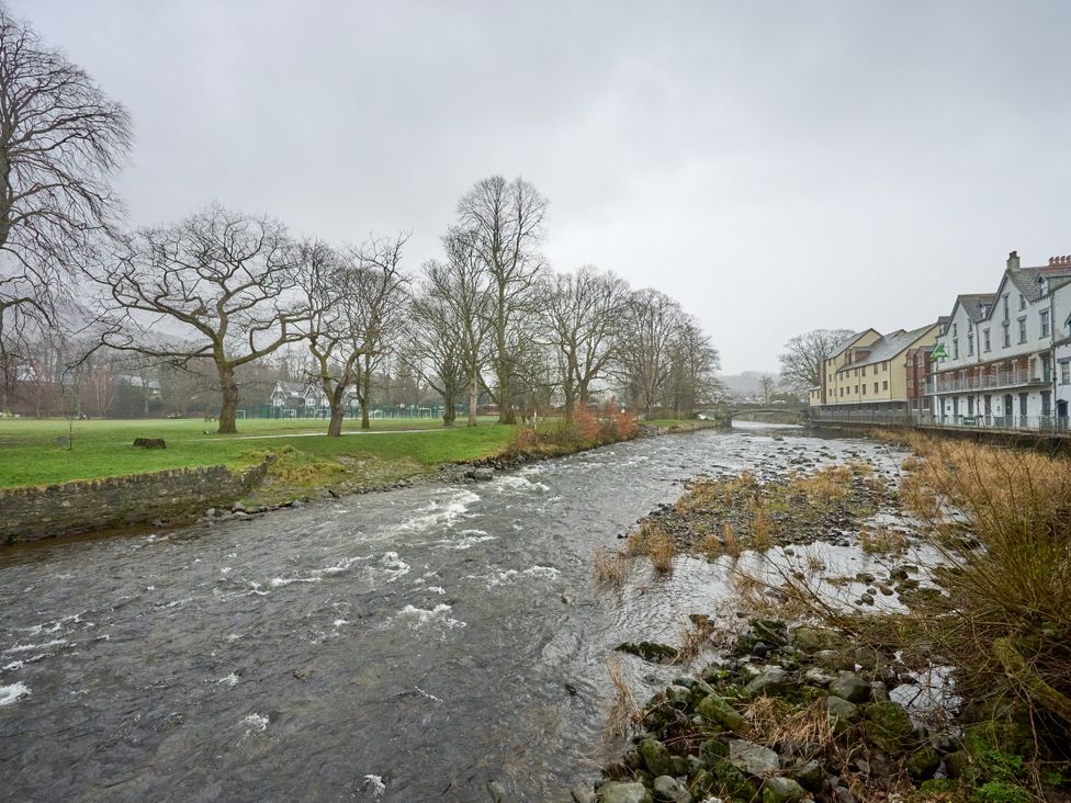 A river with trees and buildings alongside at Riverside Park 1 in Keswick