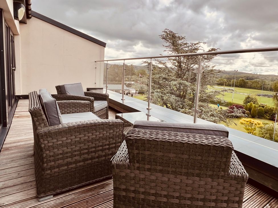 A balcony with chairs and railing at River View in Garstang