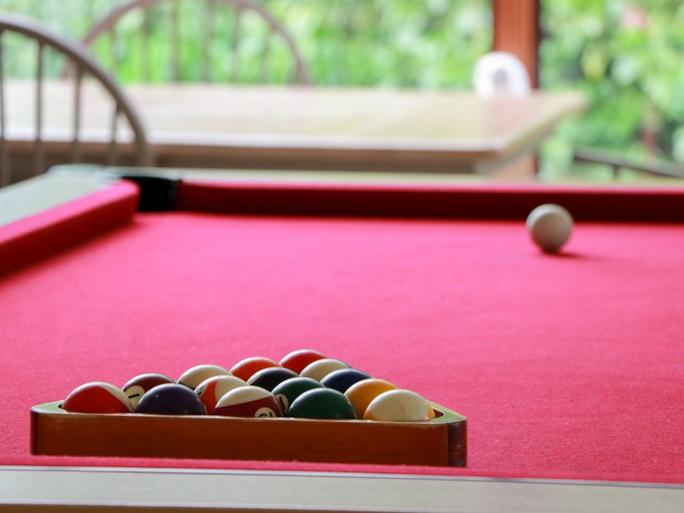 A pool table with balls arranged in a rack at Shieldhill Farm House in Falkirk