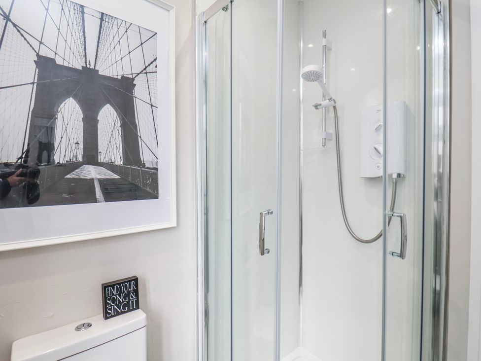 A bathroom featuring a shower and toilet at 24 Baxtergate, Whitby