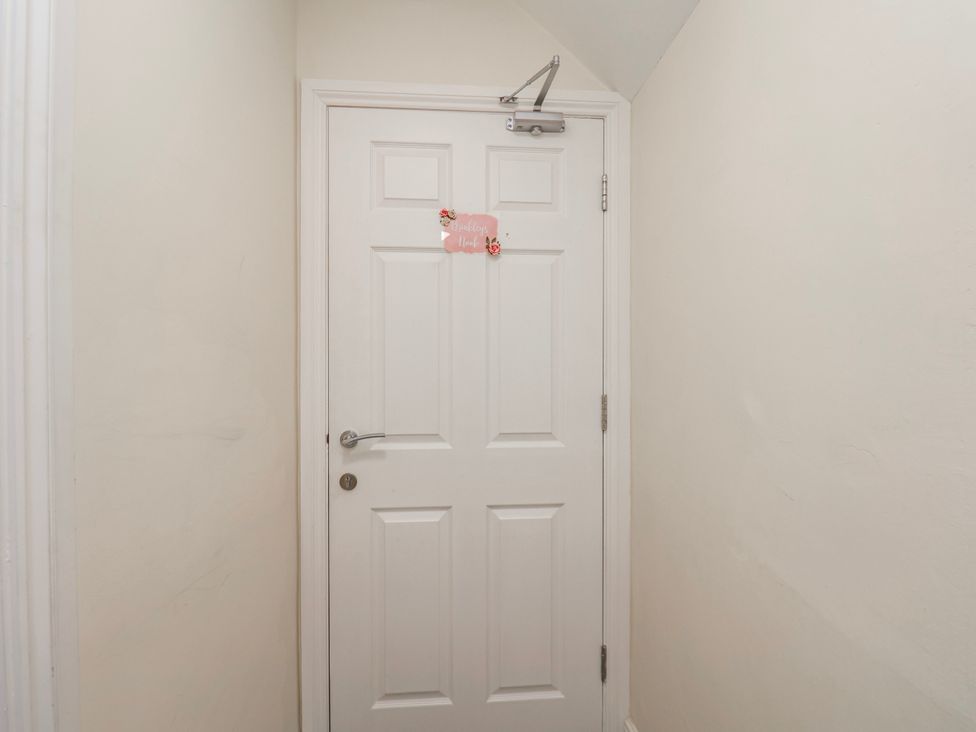 A door with a sign in a hallway at 24 Baxtergate in Whitby