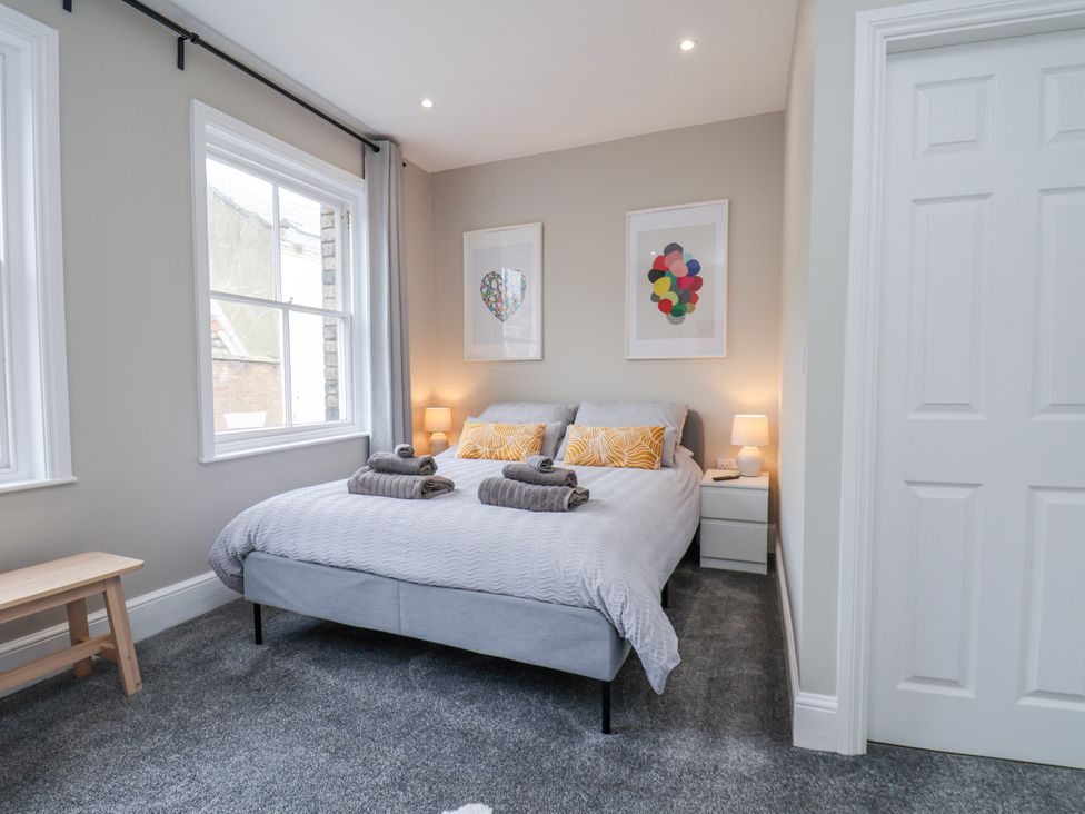A bedroom with a bed and bedside table at 24 Baxtergate, Whitby