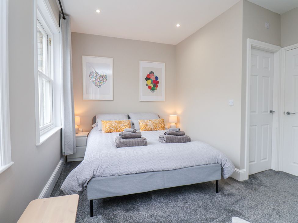 A bedroom with a bed and bedside tables at 24 Baxtergate in Whitby
