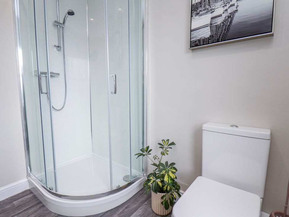 A bathroom with a shower and a toilet at 24 Baxtergate in Whitby