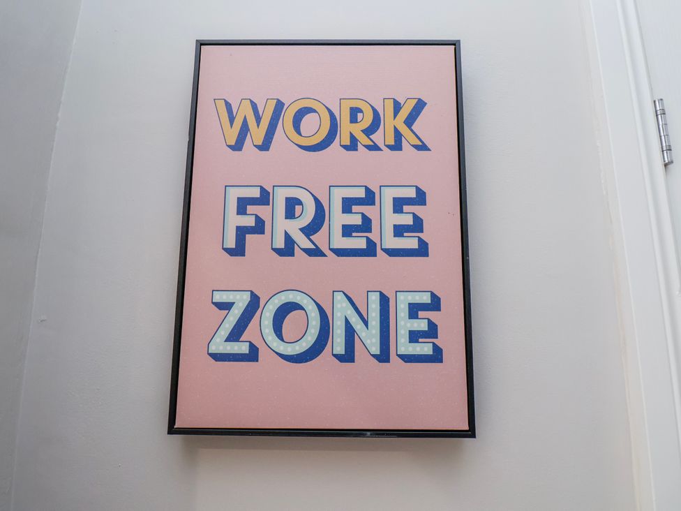 A framed wall art with the text 'WORK FREE ZONE'