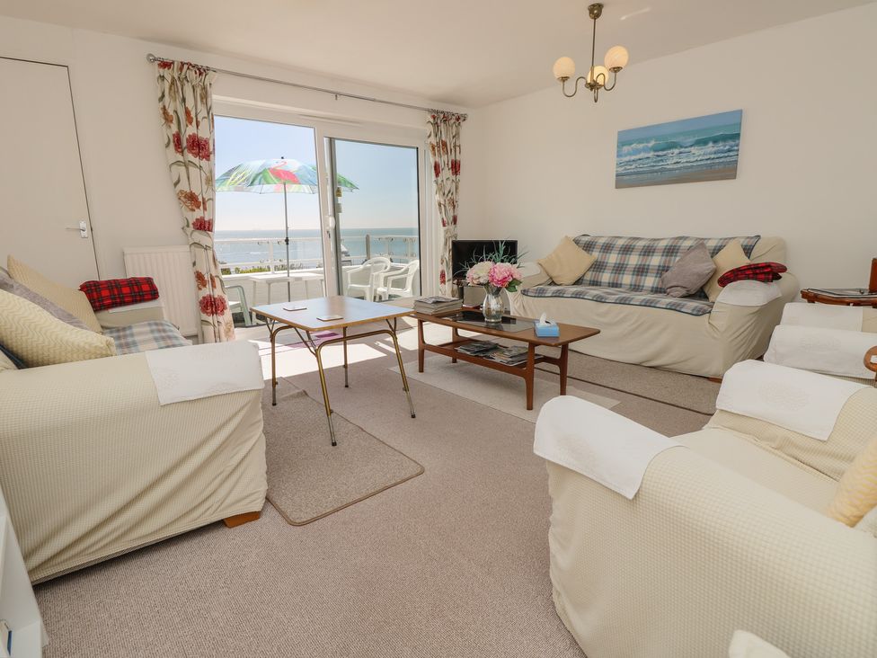 A living room with a sofa and table at Bella vista in Selsey, West Sussex