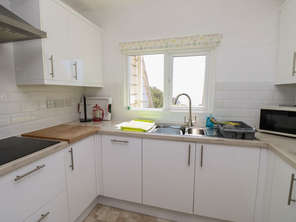 A kitchen with a sink and window at Bella vista in Selsey, West Sussex