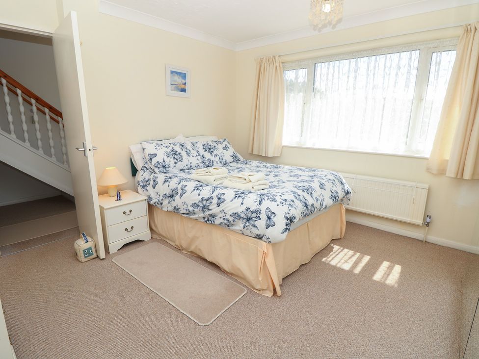 A bedroom with a bed and bedside table at Bella vista in Selsey, West Sussex