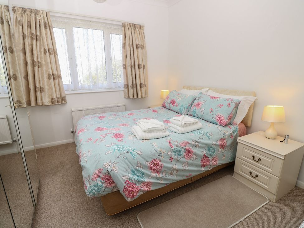 A bedroom with a bed and bedside table at Bella vista in Selsey, West Sussex
