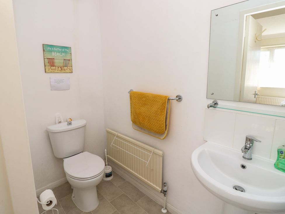 A bathroom with a toilet and sink at Bella vista in Selsey, West Sussex