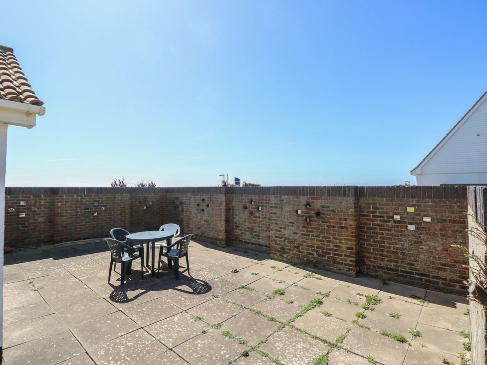An outdoor area with a table and chairs at Bella Vista Selsey, West Sussex