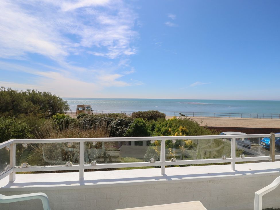 A view of the sea and plants from a balcony at Bella Vista in Selsey, West Sussex