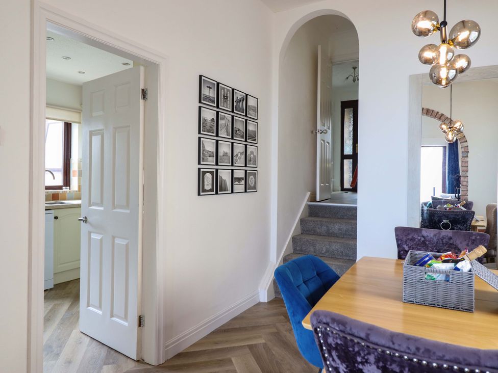 A dining room with a table and chairs at Ser a Mor (Stars and Sea) Bull Bay near Amlwch
