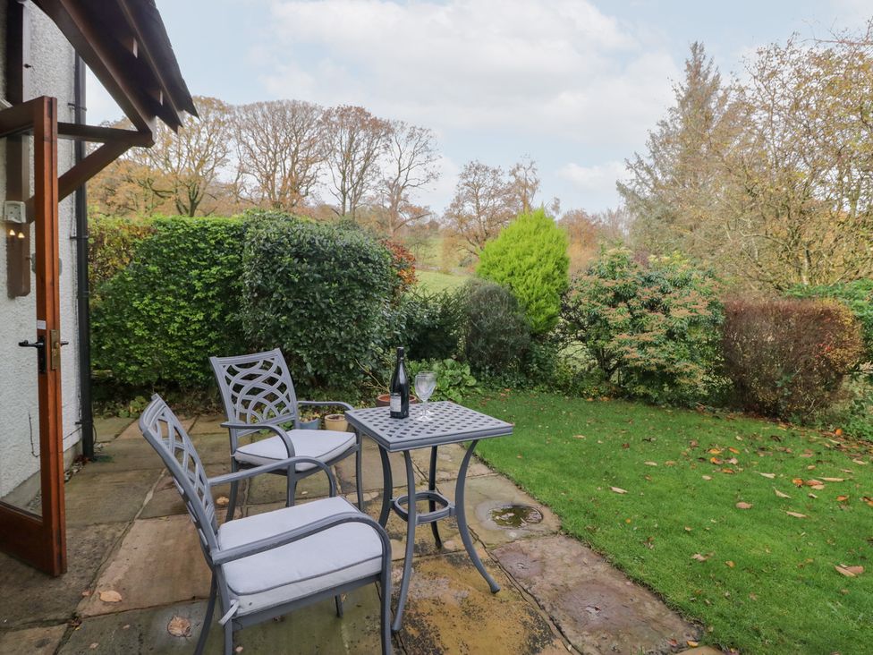An outdoor seating area with table and chairs at Low Dow Crag in Coniston
