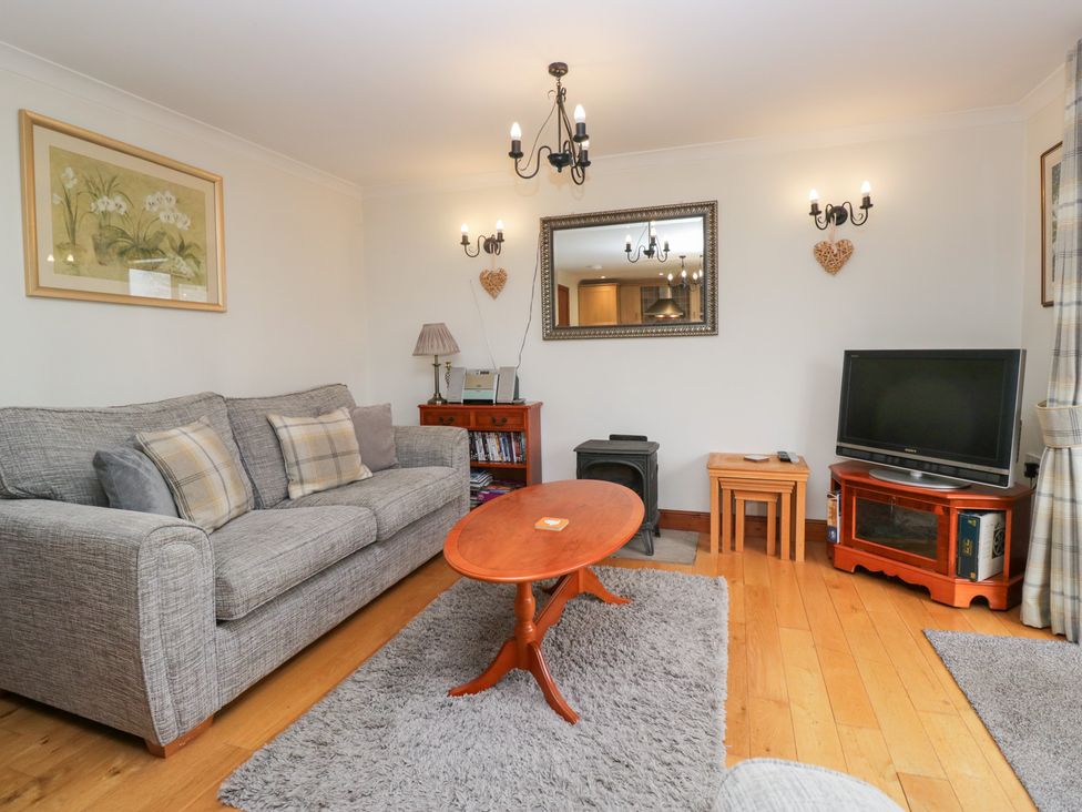 A living room with a sofa and a television at Low Dow Crag in Coniston