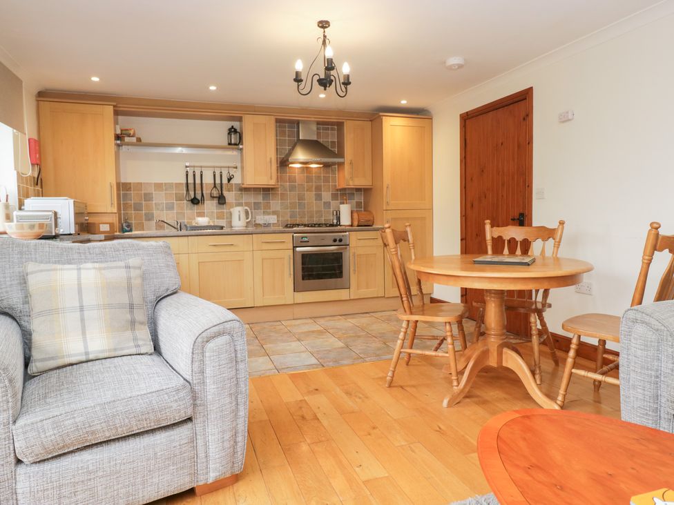 A kitchen with a dining table and chairs at Low Dow Crag in Coniston