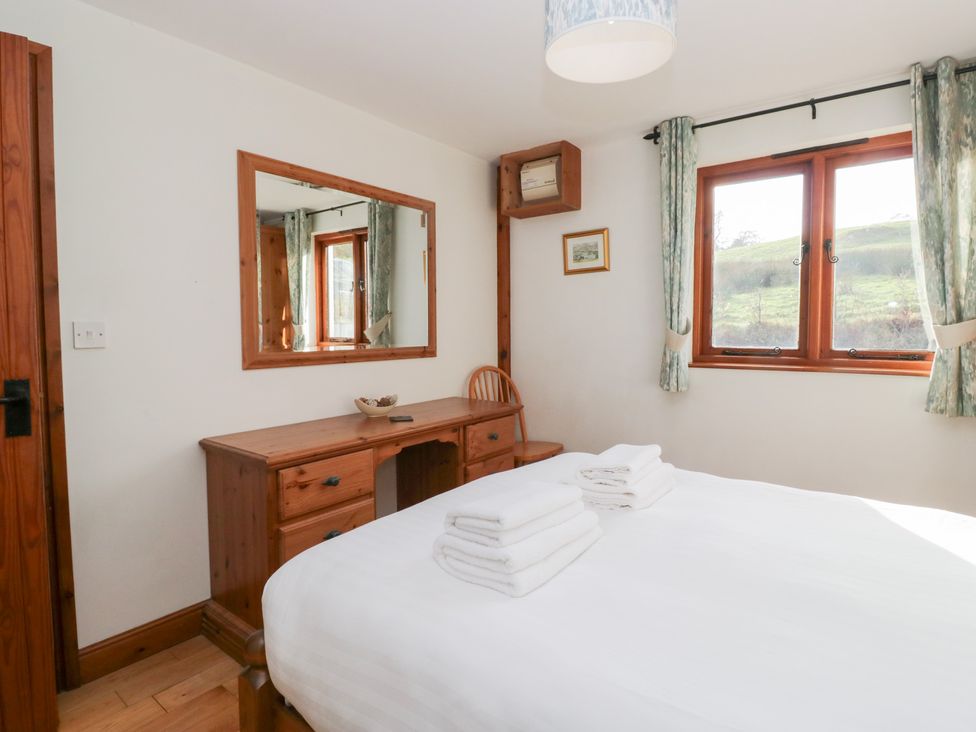 A bedroom with a bed and desk at Low Dow Crag in Coniston