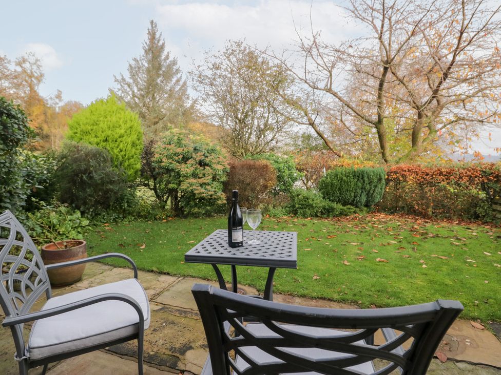 A garden with a table and chairs at Low Dow Crag in Coniston