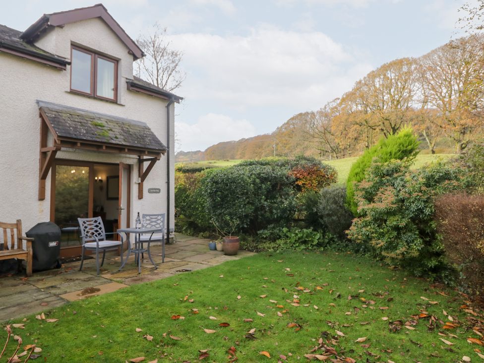 A garden with table and chairs outside at Low Dow Crag in Coniston