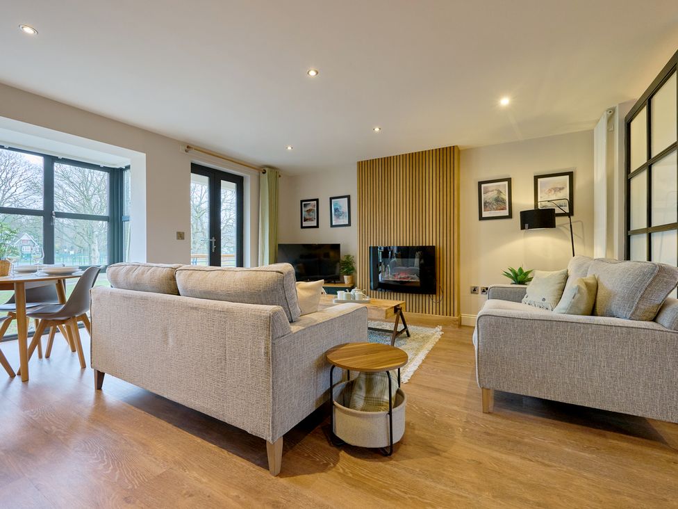 A living room with a sofa and table at Riverside Park 3 in Keswick
