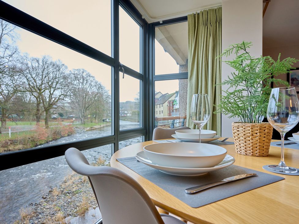 A dining room with a table set for dinner at Riverside Park 3 in Keswick