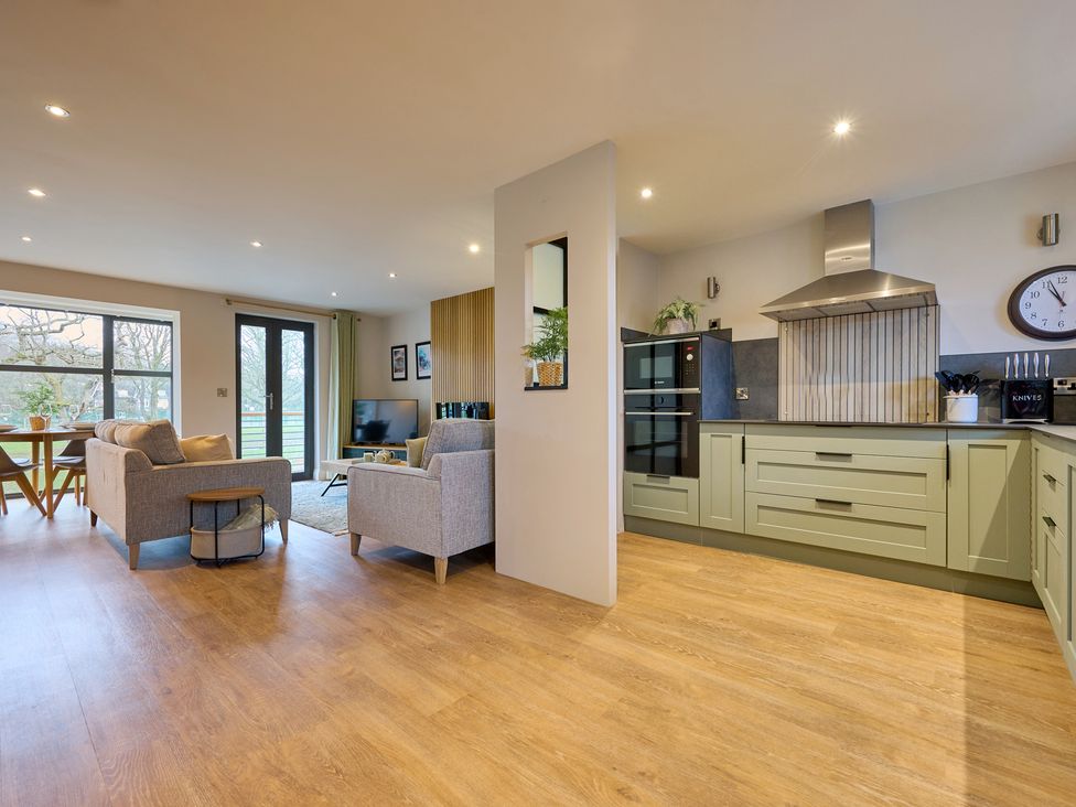 A kitchen with a seating area and television at Riverside Park 3 in Keswick