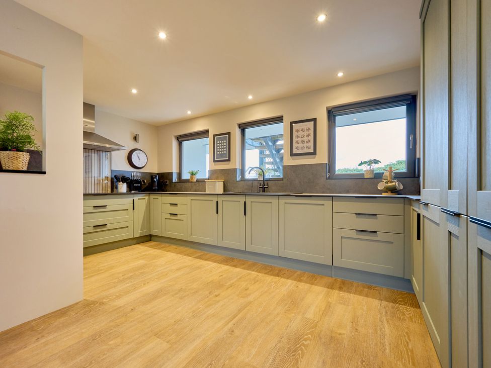 A kitchen with cabinets and a sink at Riverside Park 3 in Keswick