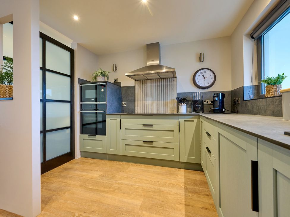 A kitchen with appliances and cabinetry at Riverside Park 3 in Keswick