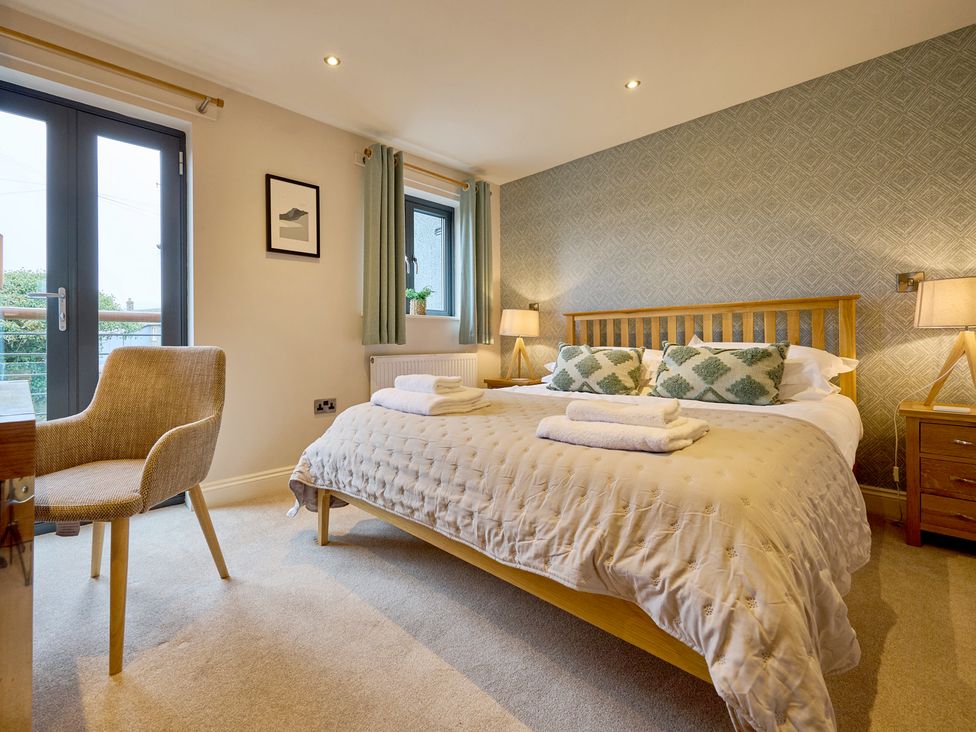 A bedroom with a bed and desk at Riverside Park 3 Keswick