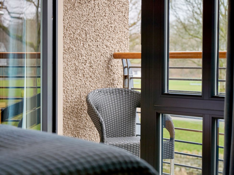 A balcony view with a chair at Riverside Park 3 in Keswick
