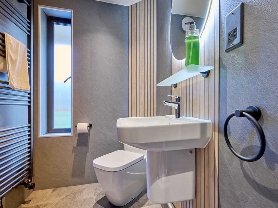 A bathroom with a sink and toilet at Riverside Park 3 in Keswick