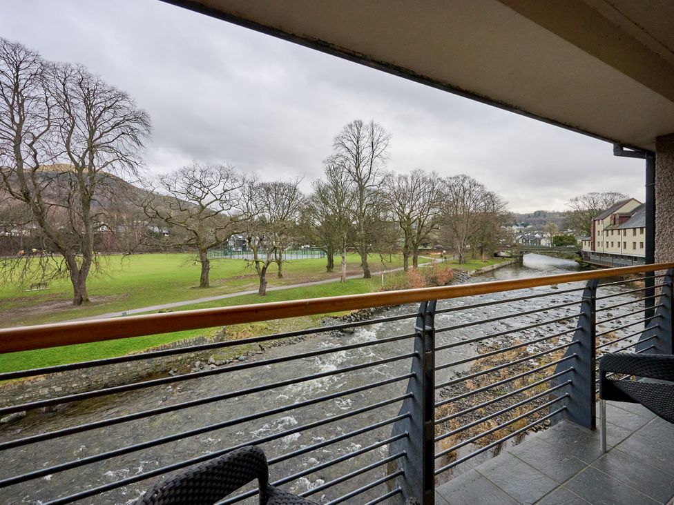 A balcony view of a river and trees at Riverside Park 5 in Keswick