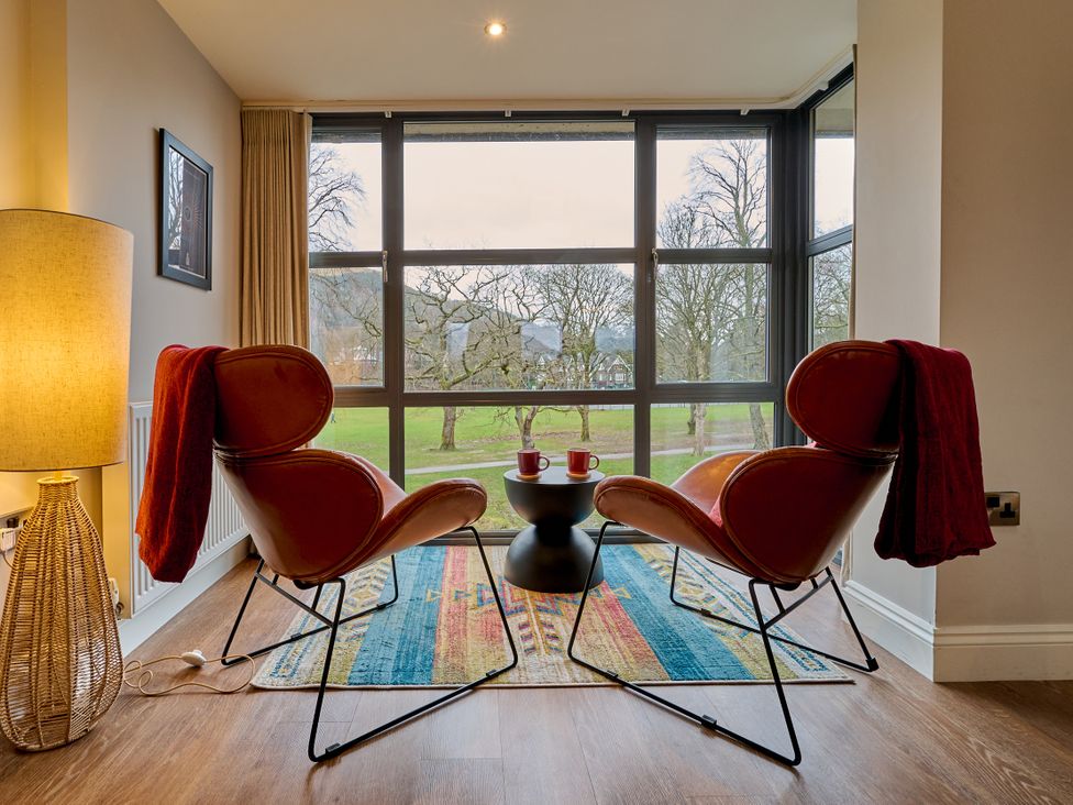 A living room with two chairs and a table at Riverside Park 5 Keswick