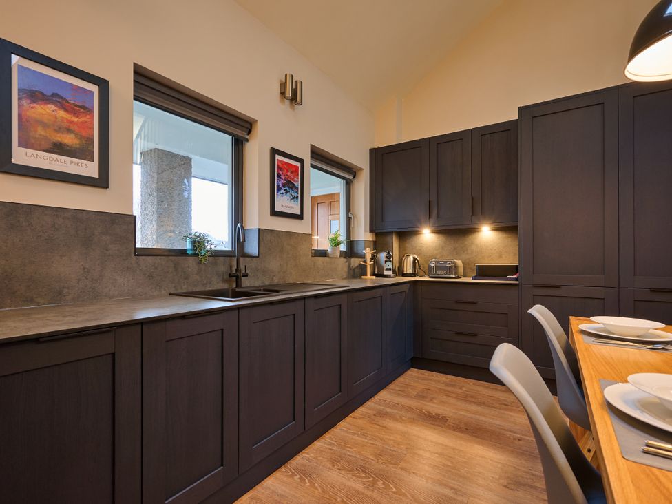 A kitchen with modern cabinetry and appliances at Riverside Park 5 in Keswick