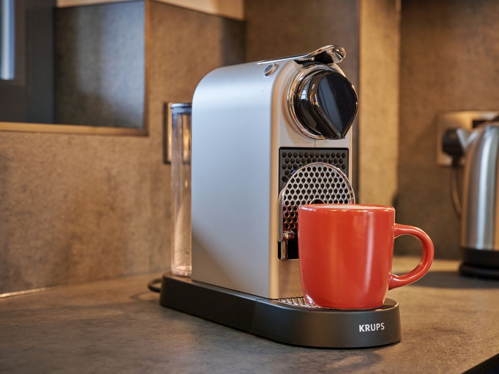 A coffee maker and a red mug in a kitchen at Riverside Park 5 in Keswick