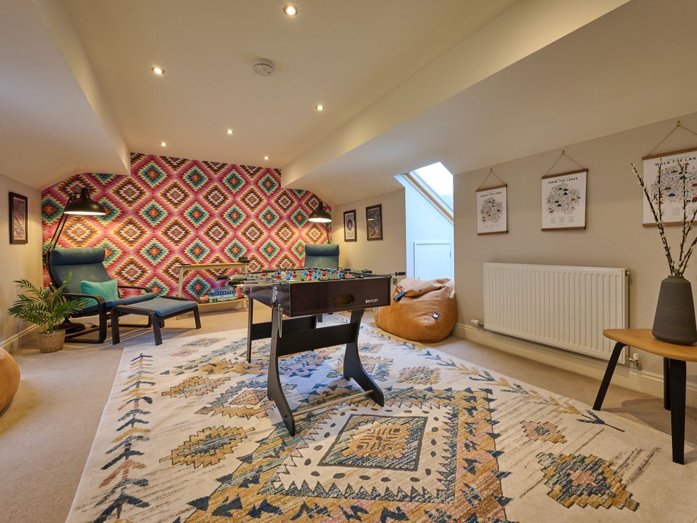 A recreation room with a foosball table and chairs at Riverside Park 5 Keswick
