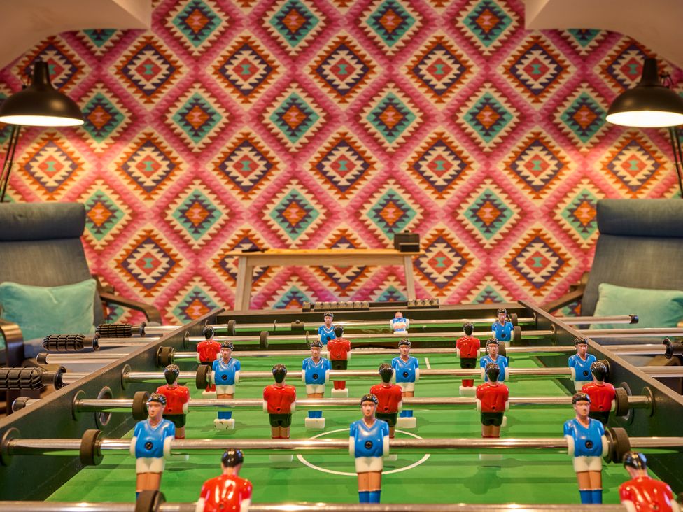 A foosball table with players in a game room at Riverside Park 5 in Keswick