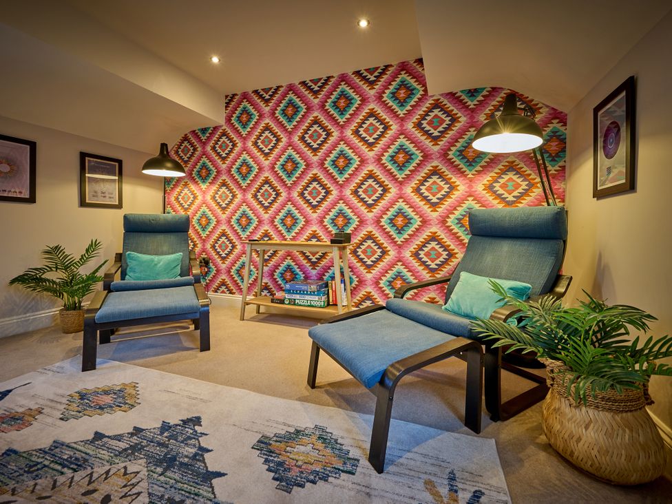 A snug with two recliners and a table at Riverside Park 5 in Keswick