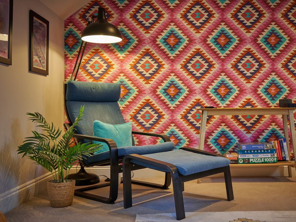 A living room with an armchair and footrest at Riverside Park 5 in Keswick