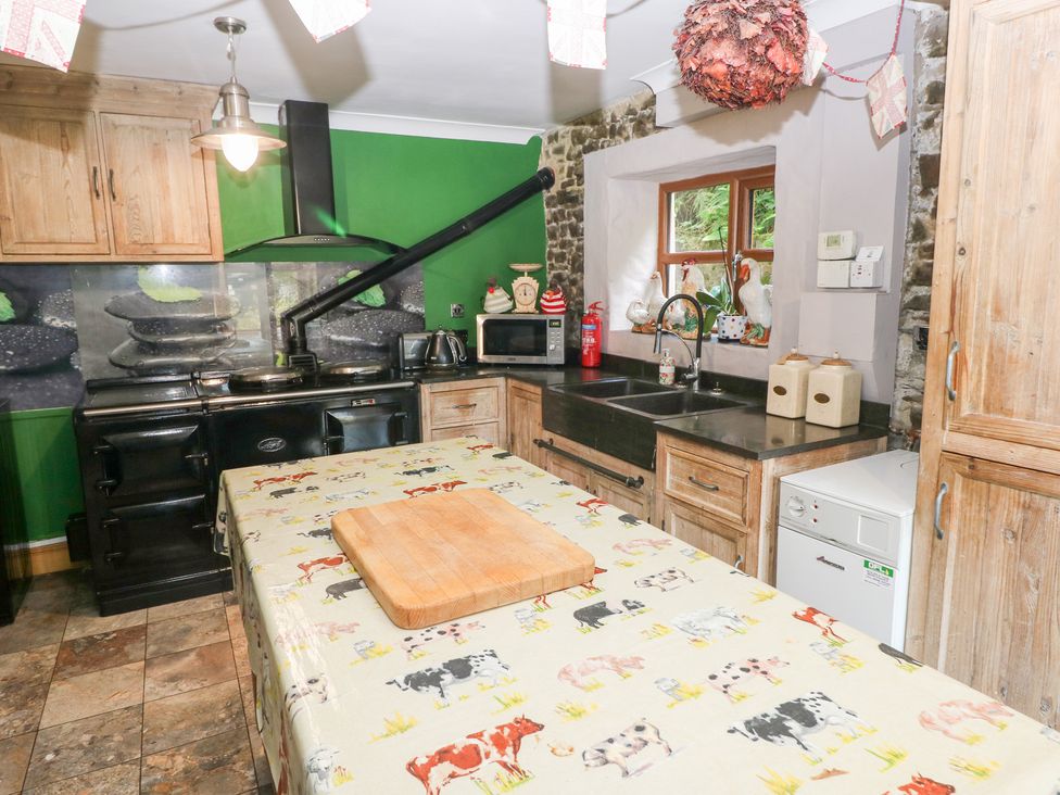 A kitchen with wooden cabinetry and appliances at The Woodlands Lower Level in Stepaside