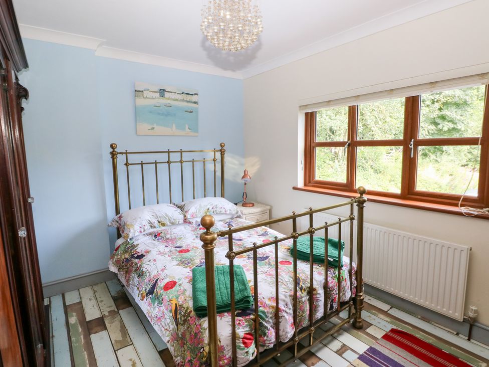 A bedroom with a bed and window at The Woodlands Lower Level Stepaside