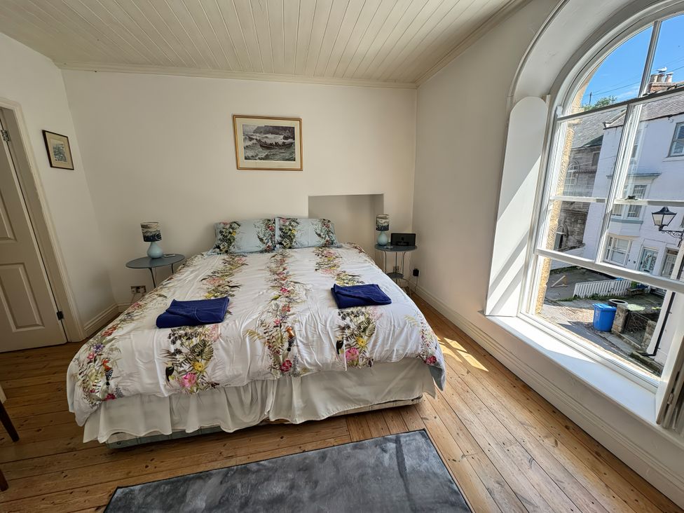 A bedroom with a bed and window at Bethel Chapel in Staithes