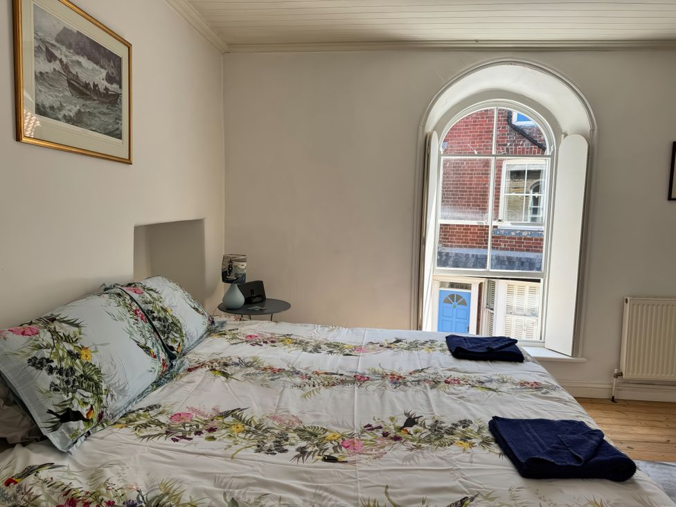 A bedroom with a bed and window at Bethel Chapel in Staithes