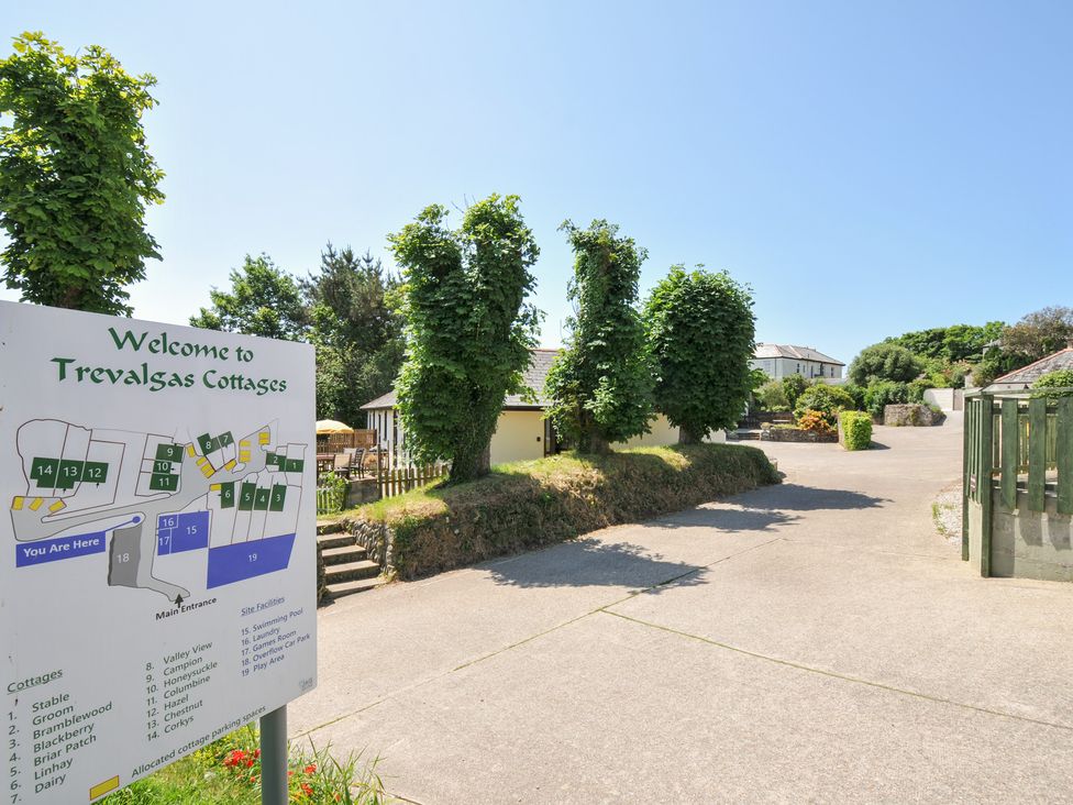 An outdoor area with a sign and cottages at Trevalgus Cottages in Bude