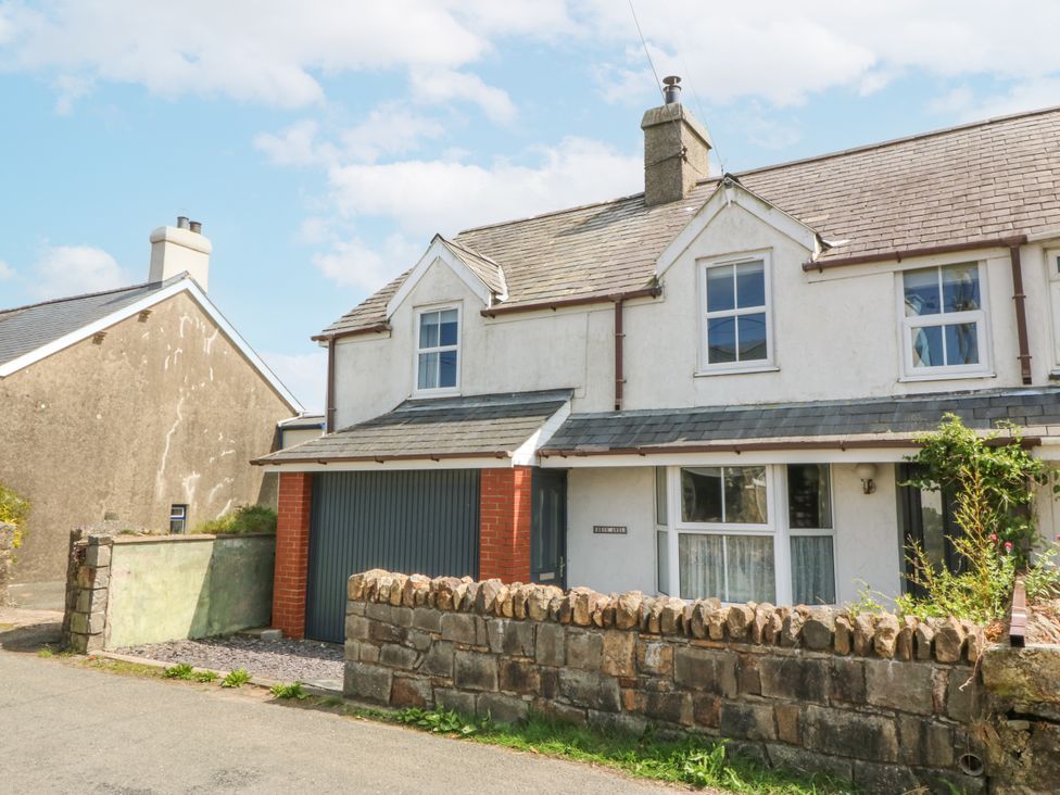 A house with a garage and a garden wall at Bryn Awel Mynytho near Abersoch