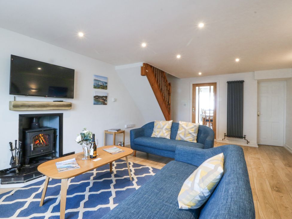 A living room with sofa and television at Bryn Awel in Mynytho near Abersoch