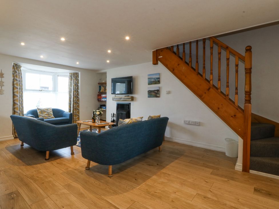 A living room with a sofa and television at Bryn Awel in Mynytho near Abersoch